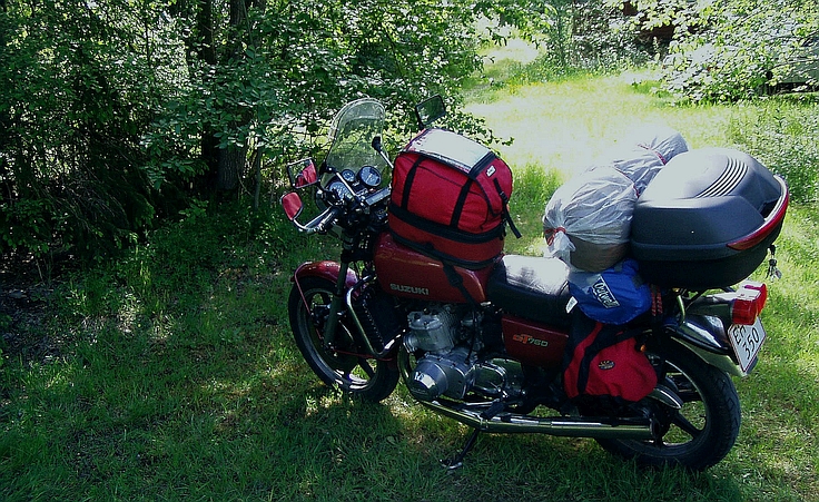 Image with Suzuki GT 750 heavily packed, and landscape, Norway
